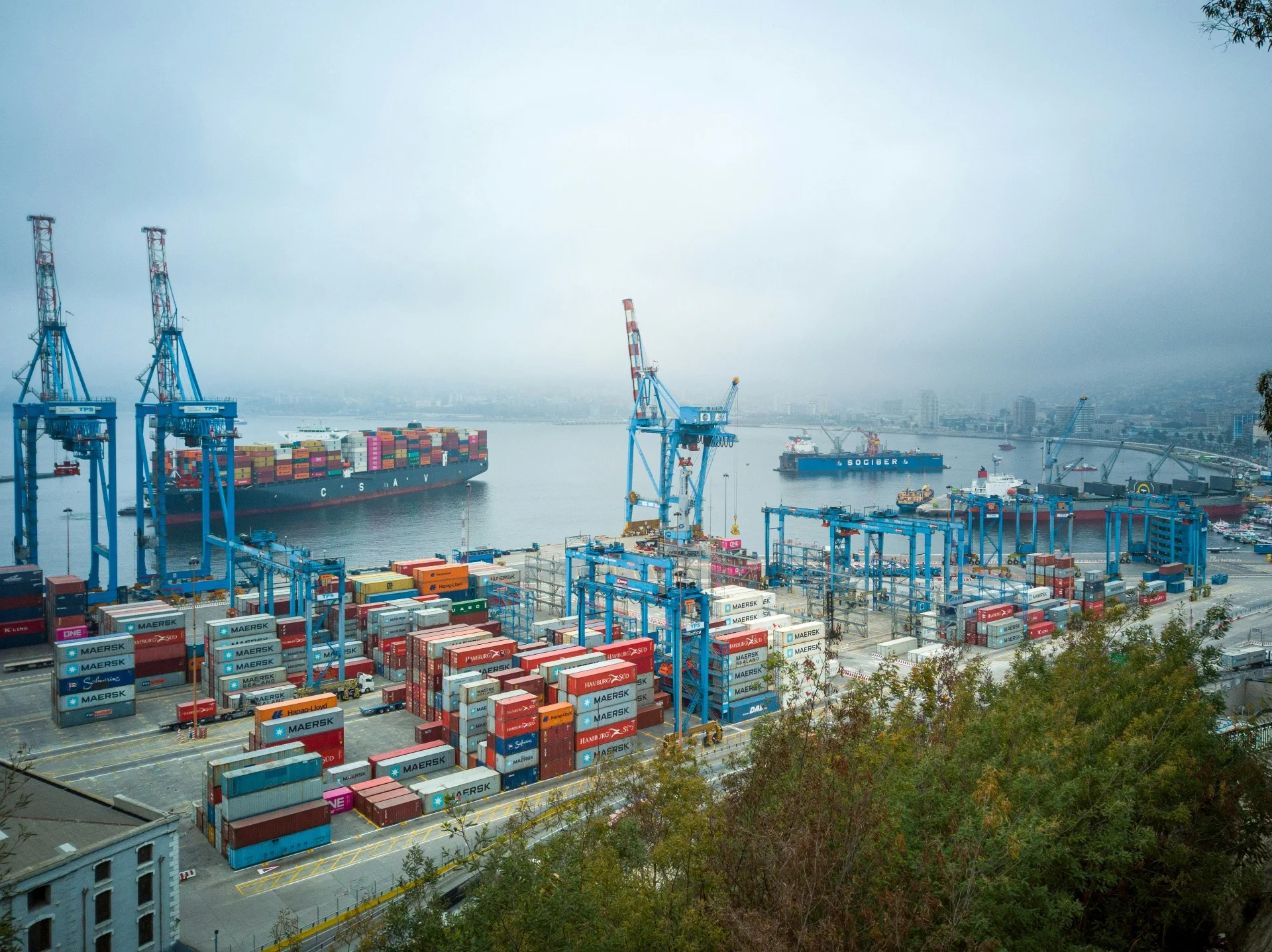 Container port at twilight with compliance and duty recovery overlays